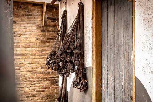 Drying retro fishing nets on the wall of old fisherman's house