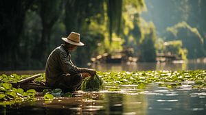 Vietnamischer Fischer mit einer Wiederverwendung an einem See in Vietnam