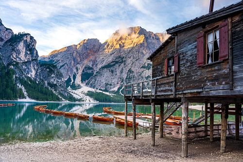 Wooden boats line the shoreline of Pragser Wildsee, Braies Lake,