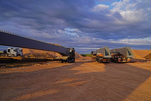 Arrival of heavy goods vehicles with bridge girders