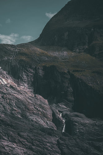 A dark rock face in the mountains