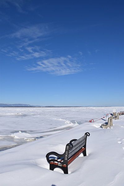 A bench on the dock in winter by Claude Laprise