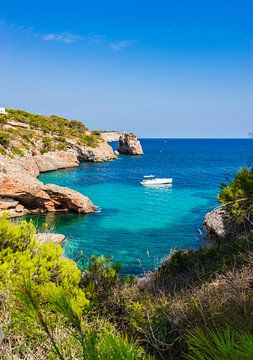 Luxury yacht anchoring at the rocky coast on Mallorca, by Alex Winter