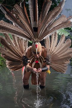 Dayak drink water from the river by Anges van der Logt