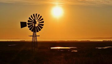 Windmill water pump at sunrise by Werner Lehmann