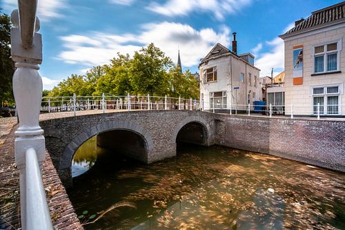 Old town of the city of Kampen with city canal and cumulus clouds in the Netherlands