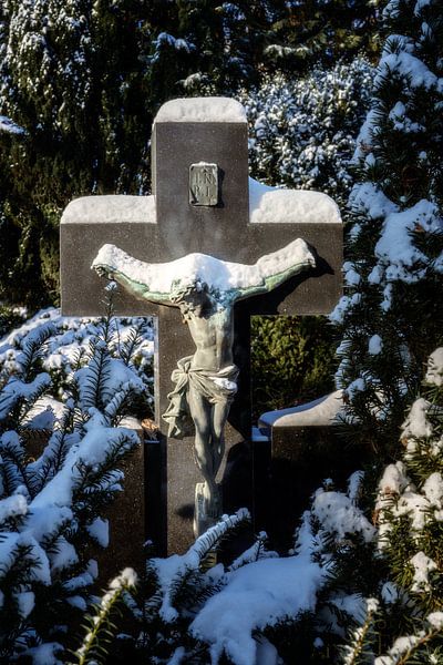Snow-covered crucifix in a cemetery by ManfredFotos
