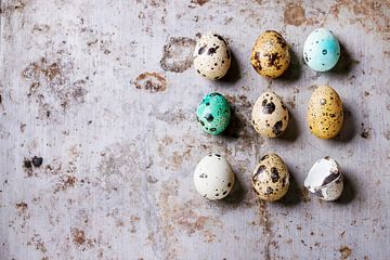 Decor whole and broken colorful Easter quail eggs standing in row rusty metaltexture background by BeeldigBeeld Food & Lifestyle