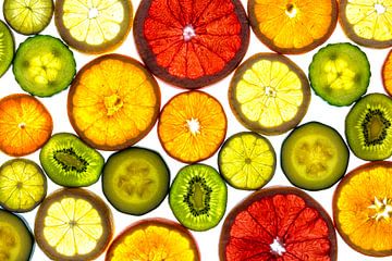 Collage of slices of fruit and vegetables with a white background. by Carola Schellekens