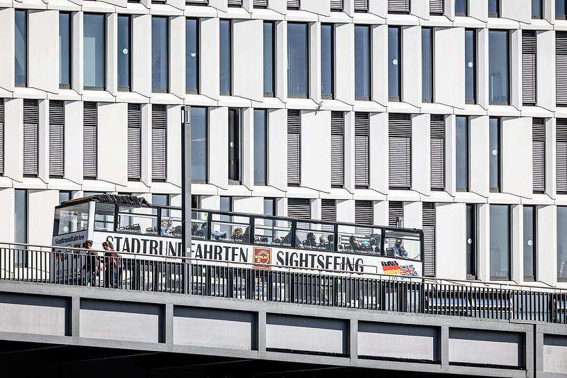 sightseeing bus with a white building in berlin by Eric van Nieuwland