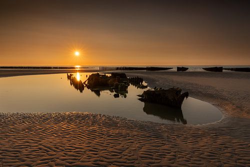 Sunset of the English shipwreck Épave Du Lord Grey on the coast in France. by Rob Christiaans