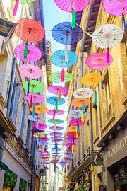 Multicolored umbrellas hanging above street by Sjoerd van der Wal Photography