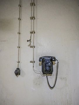 Old telephone set hanging on the wall