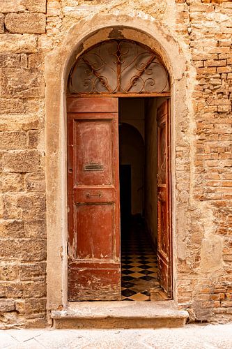 Old open wooden door with flaking varnish