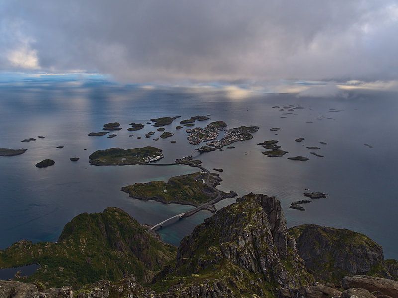 Fishing village Henningsvær on islands in Lofoten, Norway from bird's eye view on cloudy summer day by Timon Schneider