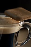 coffee cup with coffee biscuit on rim