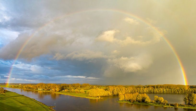 Rainbow during an autumn rain shower over the river IJssel by Sjoerd van der Wal Photography