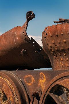 Blown-up steam boiler of a locomotive. Rusting steel at a scrap yard. by Albert Brunsting