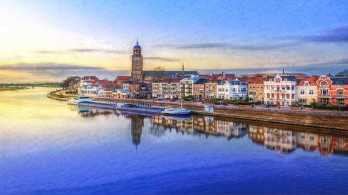 View of Deventer and the Welle with yellow-blue light and reflections in the water