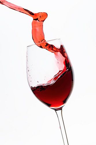 Red wine flows into the wine glass