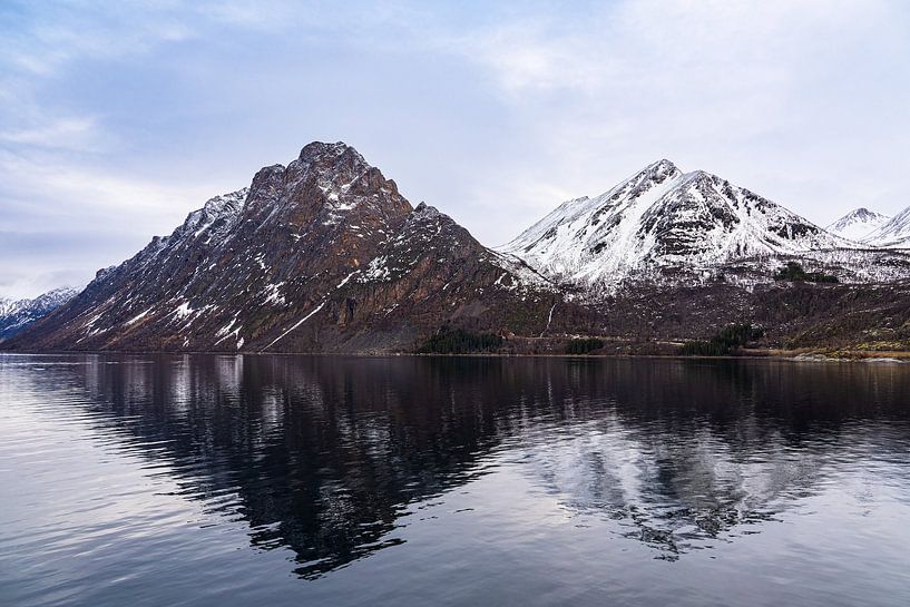 Mountains and rocks in winter near Harstad in Norway by Rico Ködder