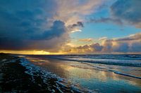 Sea with sun behind clouds