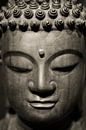 Hoofd van een stenen Buddha beeld in sepia van Rob van Keulen thumbnail