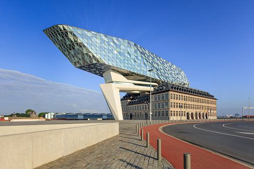 Antwerp Port House against blue sky with red cycle lane 