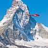 Rescue helicopter of Air Zermatt in front of the Matterhorn by Menno Boermans