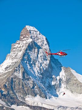 Rescue helicopter of Air Zermatt in front of the Matterhorn