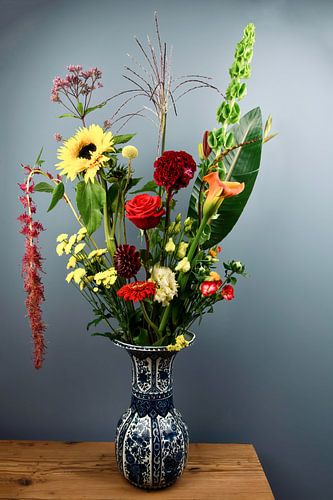 Still life: Colourful bouquet of flowers in Delft blue vase