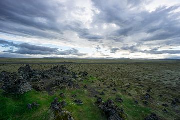 Iceland - Green lowlands and far mountains at dawn with clouds by adventure-photos