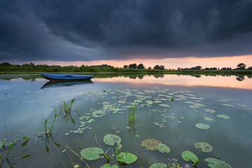Threatening sky during sunset near a small lake in the Ooijpolder.