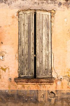 Weathered old window frame in Tuscan ambience in Buis de Baronie in France