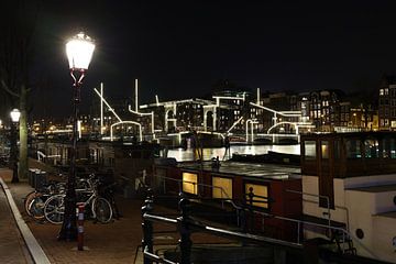 Evening photo of Amsterdam with view of canal and bicycles