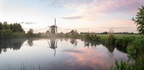 Windmill reflected in the lake of dawn