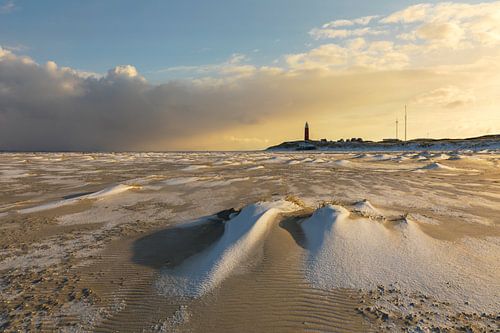 Snowy beach with red lighthouse