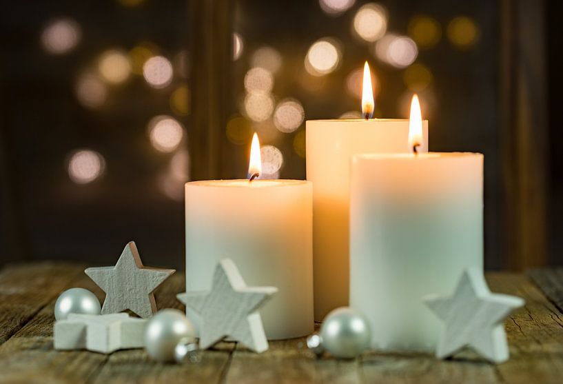 Advent and Christmas candles with white star shapes by Alex Winter