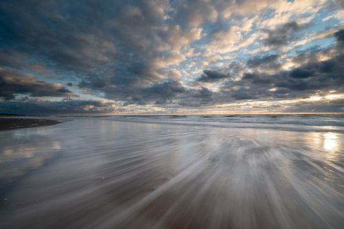 Retreating water on the beach