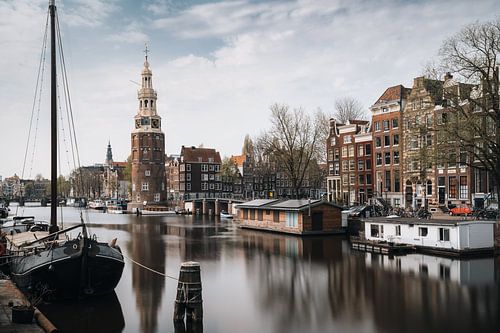 Montelbaan tower, canal and old houses in Amsterdam, the Netherlands.