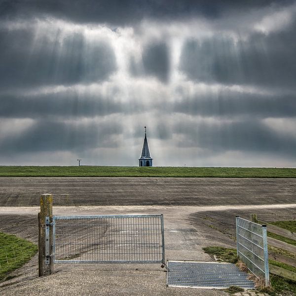 The spire of the church of Paesens/Moddergat just above the dike by Harrie Muis
