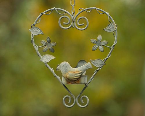 Vintage harten hanger vogel in een hart