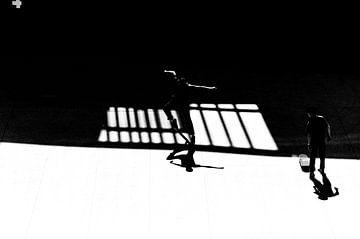 Skateboarder dancing with his shadow by Lieven Tomme