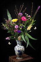 Still life colorful bouquet of flowers in vase with sparrow