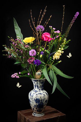 Still life colorful bouquet of flowers in vase with sparrow