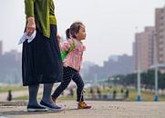 Girl with her mother in Pyongyang, North Korea by Teun Janssen thumbnail