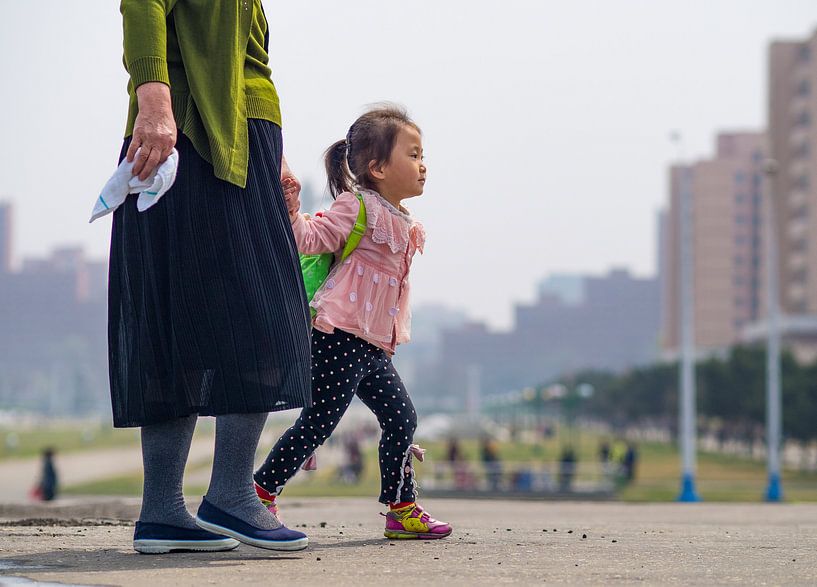 Girl with her mother in Pyongyang, North Korea by Teun Janssen
