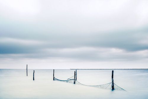 Fishing nets with wooden posts in the lake