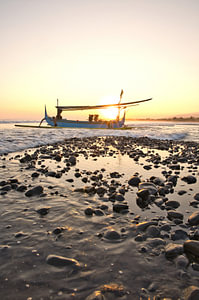 Jukung Fischerboot an der Küste im Sonnenuntergang von Medewi, Bali