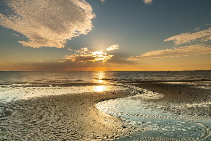 Lijnenspel op strand bij ondergaande zon van Bas Verschoor